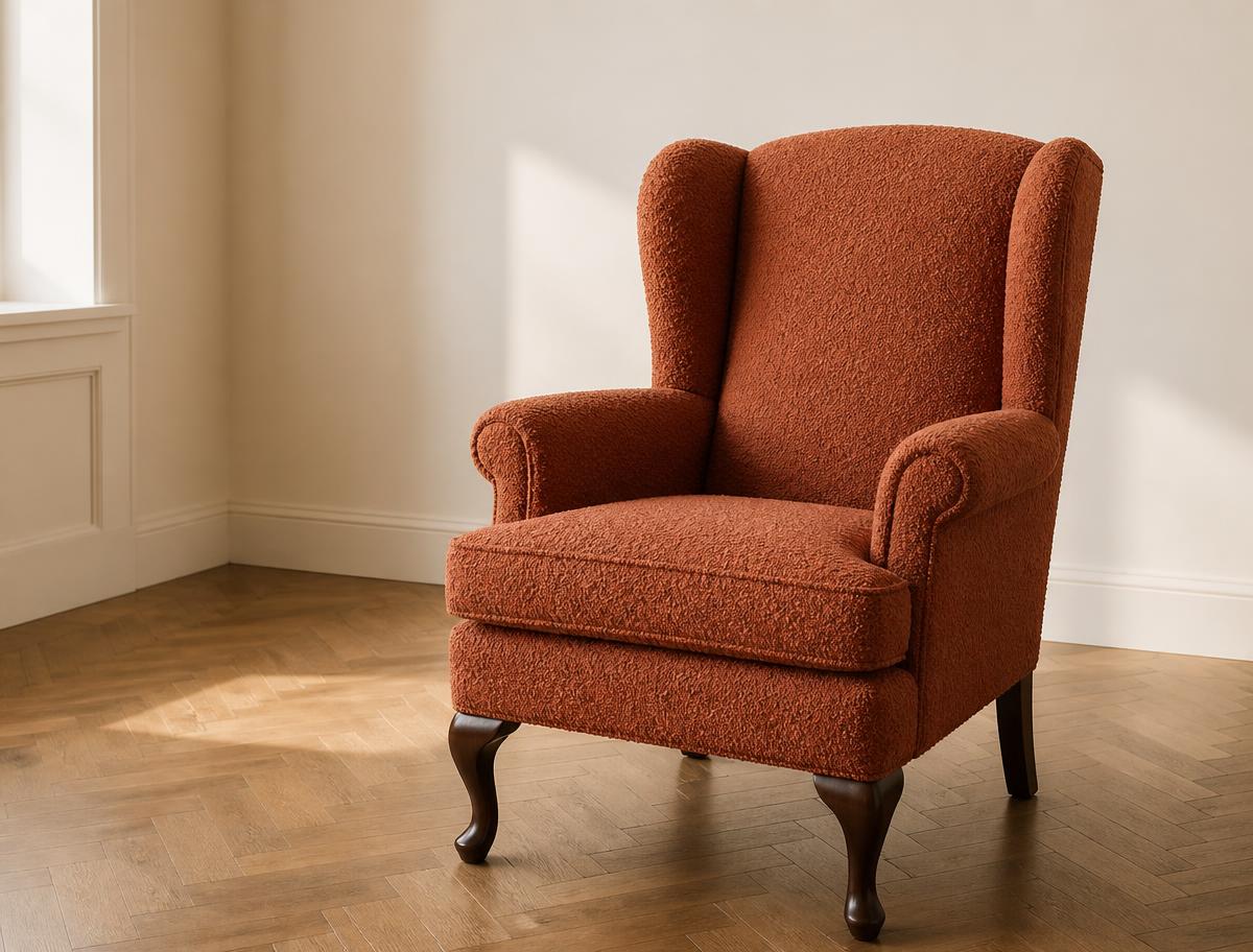 Wingback armchair reupholstered in terracotta bouclé